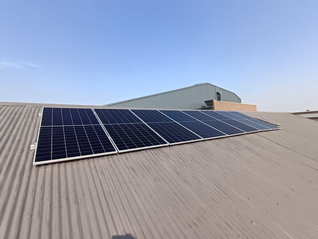 Commercial solar panel array installed on a metal roof